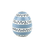 a white, black and blue striped decorative Easter egg with on white background.