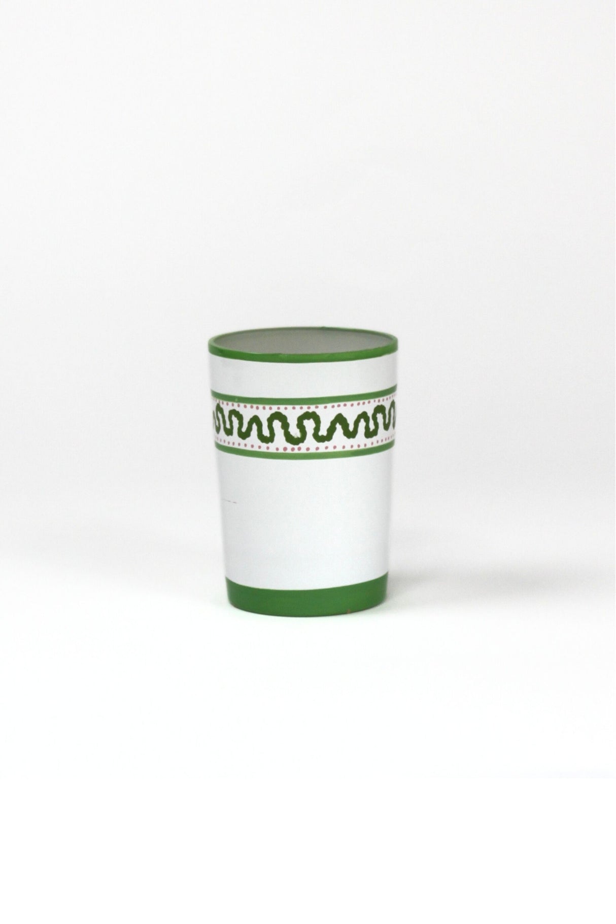 a green painted glass with a squiggly motif at the top called "Harbor Trail" by madcap cottage