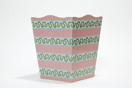 a madcap cottage pink and white striped wastepaper basket with a green squiggle down each white stripe. 