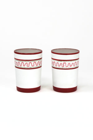 two red painted glasses with a squiggly motif at the top called "Harbor Trail" by madcap cottage