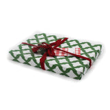 a gift wrapped in lattice print green and white wrapping paper with a red bow