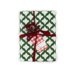 a gift wrapped in lattice print green and white wrapping paper with a red bow