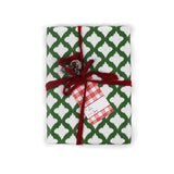 a gift wrapped in lattice print green and white wrapping paper with a red bow