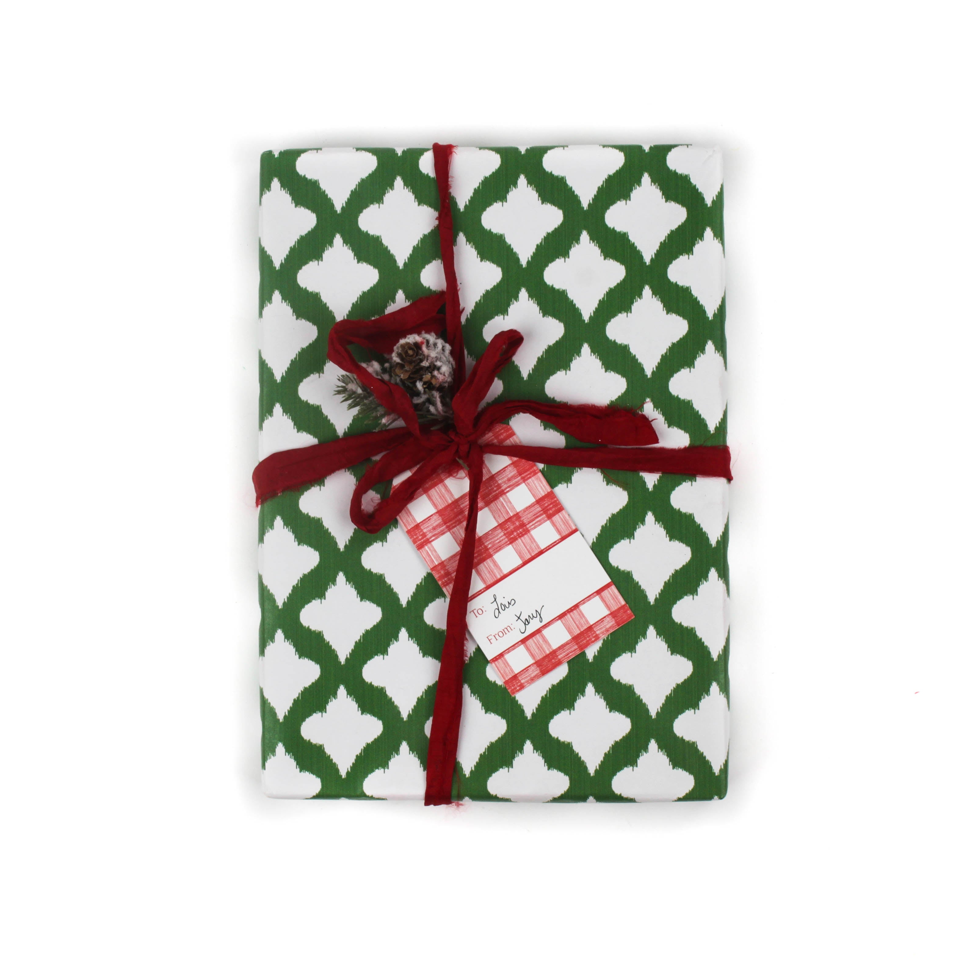 a gift wrapped in lattice print green and white wrapping paper with a red bow
