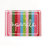 A rectangular acrylic tray with colorful striped pattern and the word 'sparkle' displayed prominently in the center.