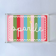 A rectangular acrylic tray with colorful striped pattern and the word 'sparkle' displayed prominently in the center.