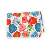 a folded christmas tea towel featuring a repeating holiday sweater design in red, pink and blue