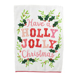 A Madcap Cottage Christmas tea towel with holly motifs and text that reads Have a Holly Jolly Christmas