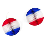 Two red white and blue honeycomb paper ball decorations hanging against a white background.