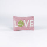 A pink pillow with the word "LOVE," where the "O" is a green tennis ball.
