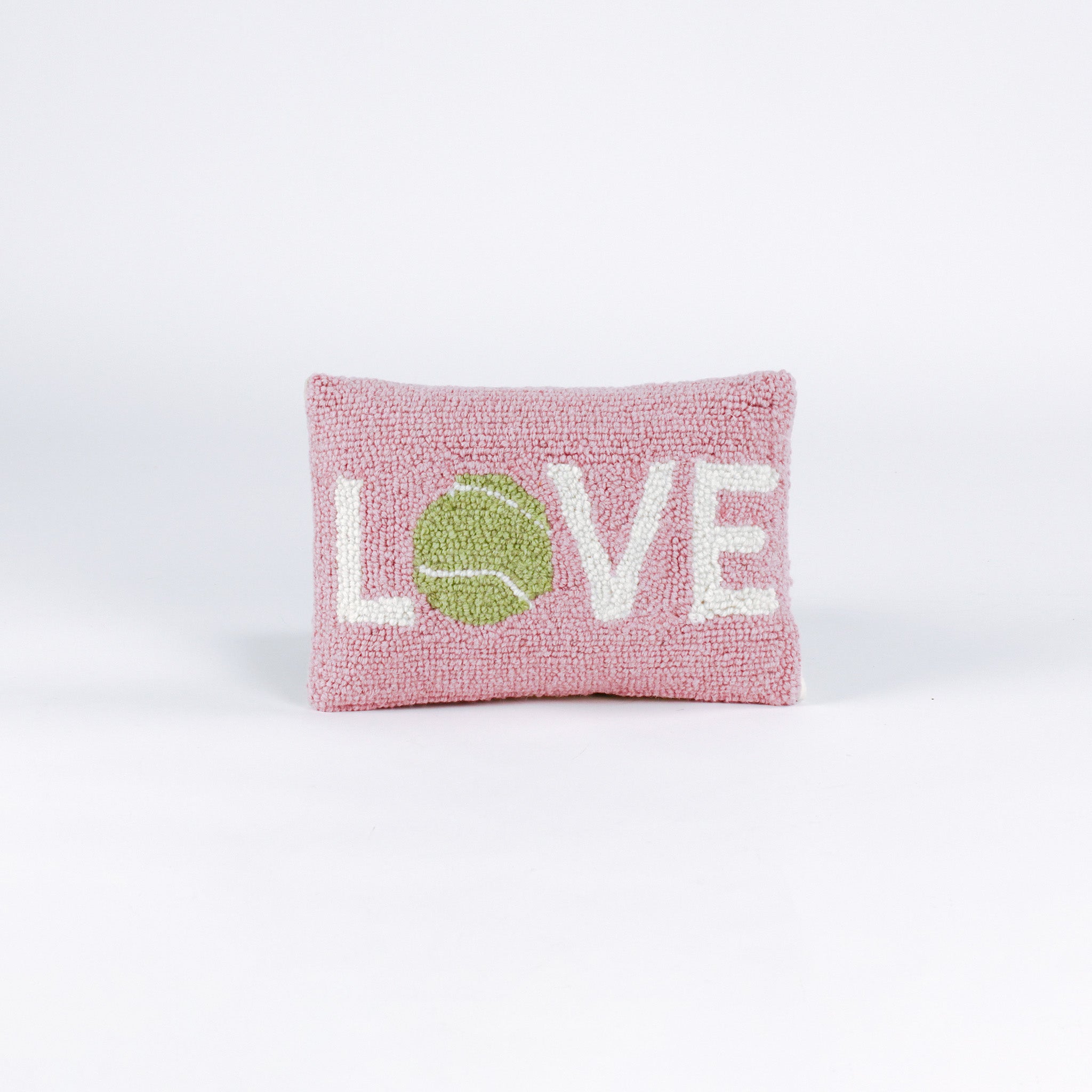 A pink pillow with the word "LOVE," where the "O" is a green tennis ball.