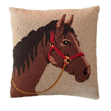 A beige horse pillow featuring a dark brown horse with a red bridle.