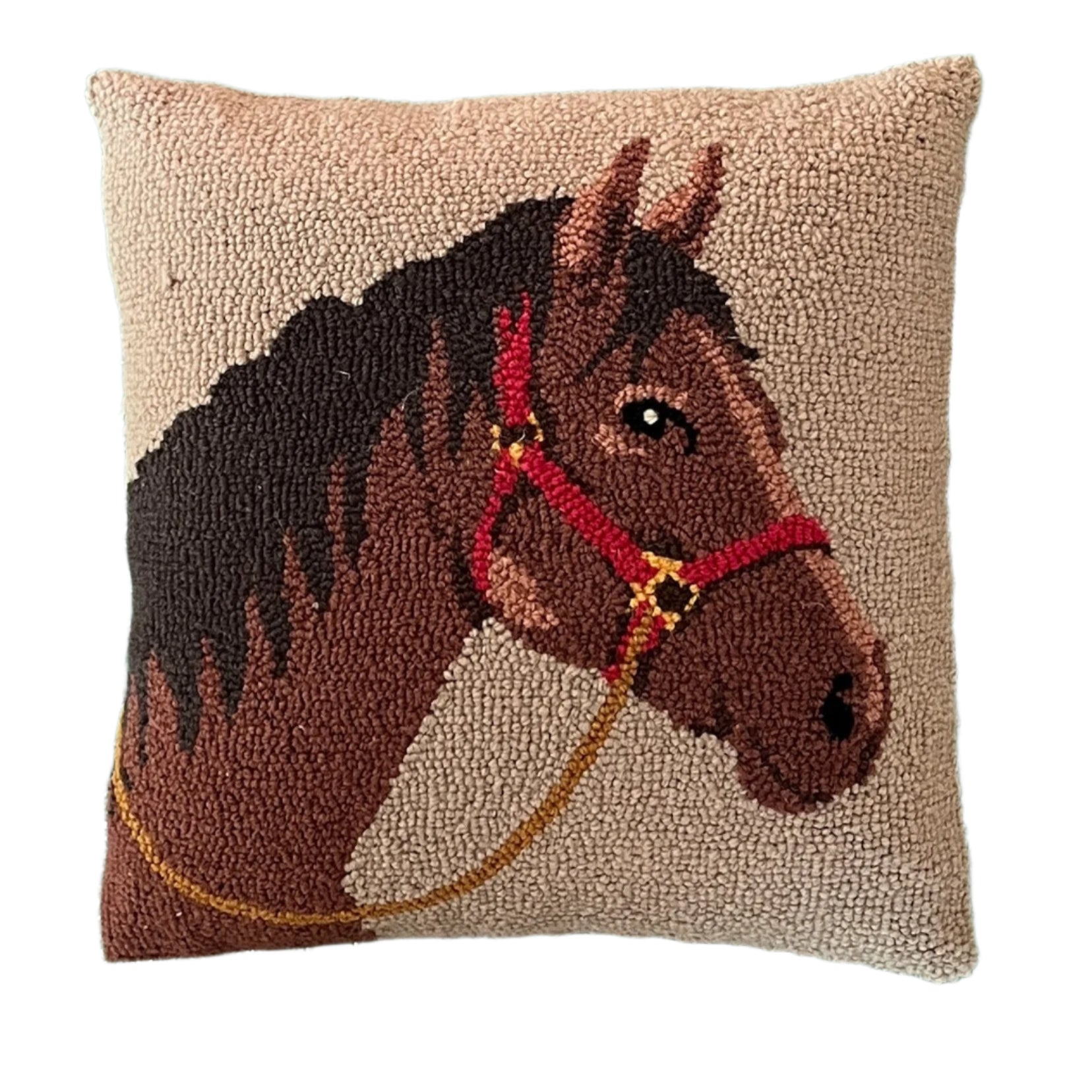 A beige horse pillow featuring a dark brown horse with a red bridle.