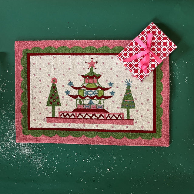 Pink and green rug with pagoda and christmas tree motifs