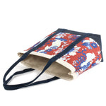 a large Imperial Palace canvas tote bag, in a red, white and blue chinoiserie pattern featuring white pug dogs