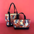 two Imperial Palace canvas tote bags, on larger than the other, in a red, white and blue chinoiserie pattern featuring white pug dogs