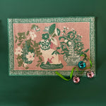 A green and pink rug with a green pug motif and a green geometric border