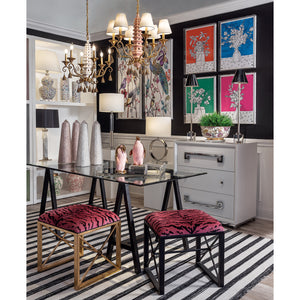 A pink pagoda chandelier hanging above a dining table. 