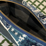 Interior view of Temple Garden toiletry bag in navy blue features light blue floral motif.