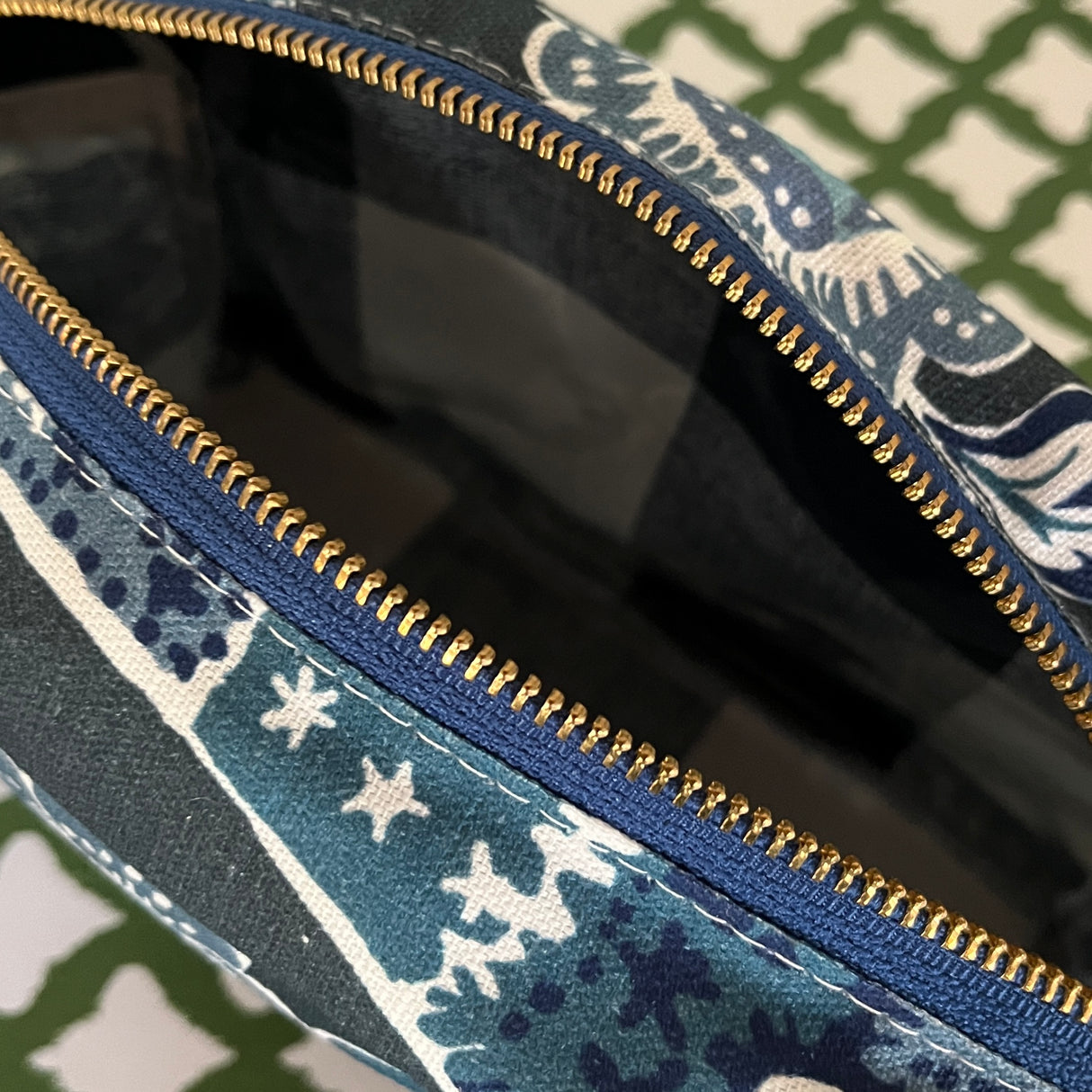 Interior view of Temple Garden toiletry bag in navy blue features light blue floral motif.