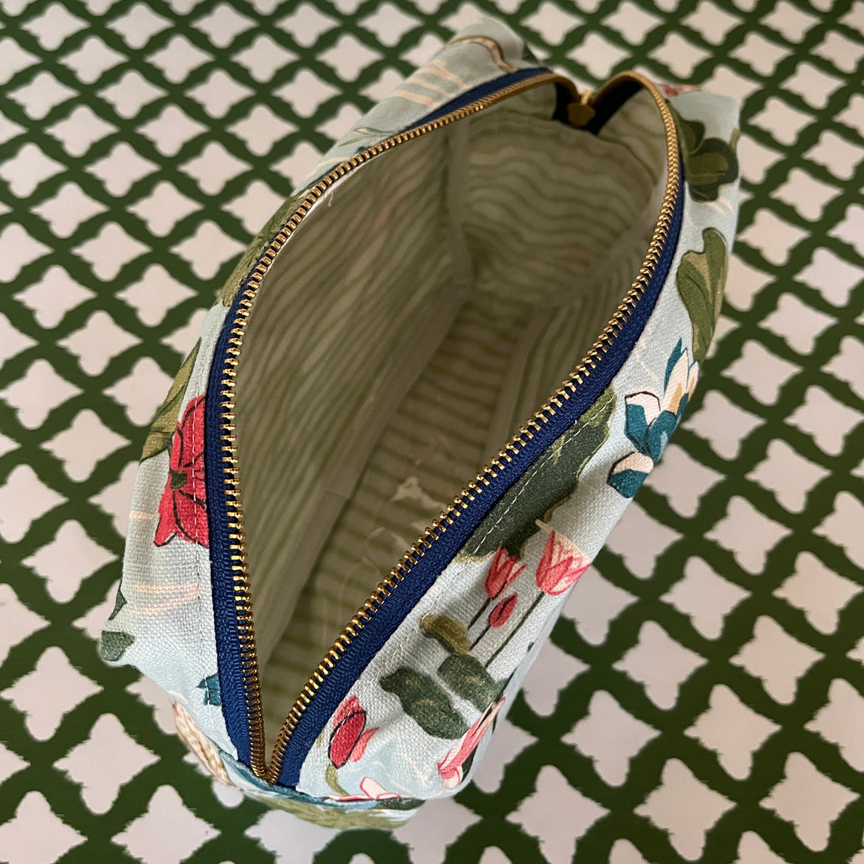 Interior view of Meadow Club toiletry bag in sky blue features a lily pond pattern