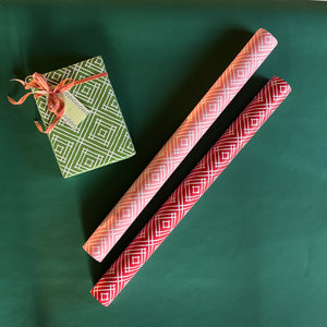 Madcap Cottage Island House Gift Wrapping Paper in 3 colors, green, pink and red.