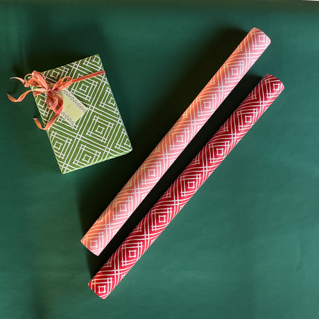 Madcap Cottage Island House Gift Wrapping Paper in 3 colors, green, pink and red.