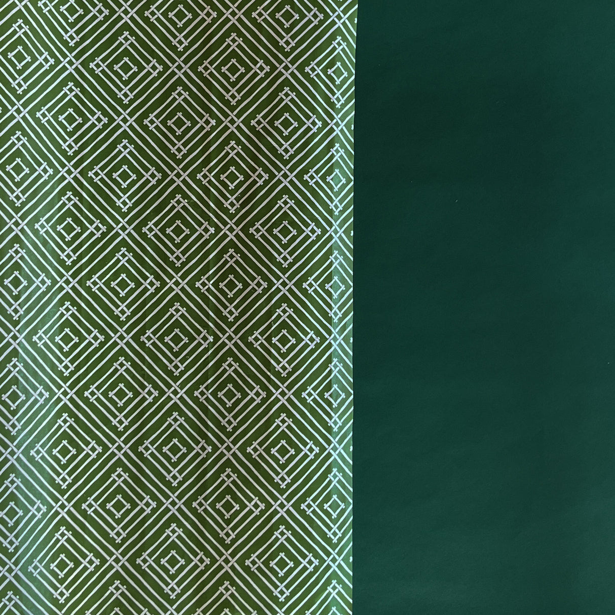 Rolls of wrapping paper with a geometric lattice pattern in green colors.