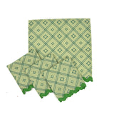 green lattice-pattern dinner napkin set with matching green scalloped edges
