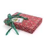 a wrapping paper with a geometric lattice pattern in red