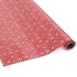 a roll of wrapping paper with a geometric lattice pattern in red