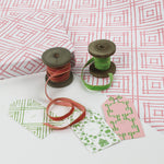 a wrapping paper with a geometric lattice pattern in pink