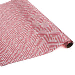 a roll of wrapping paper with a geometric lattice pattern in pink