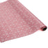 a roll of wrapping paper with a geometric lattice pattern in pink
