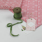 a wrapping paper with a geometric lattice pattern in pink