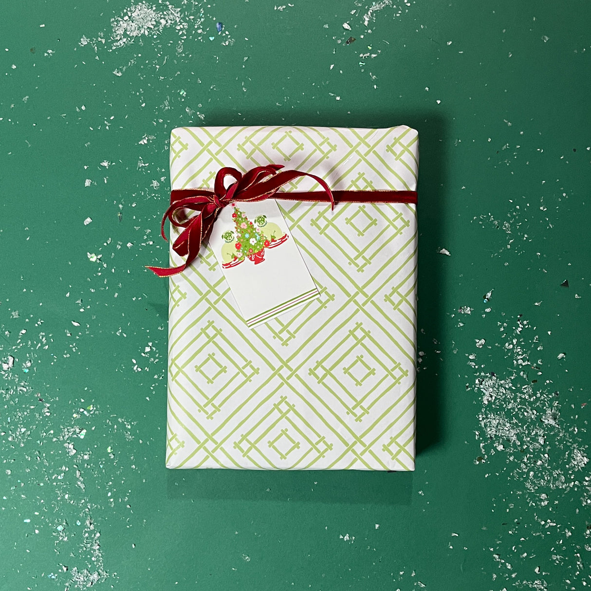 Green gift wrapping paper with a geometric lattice pattern