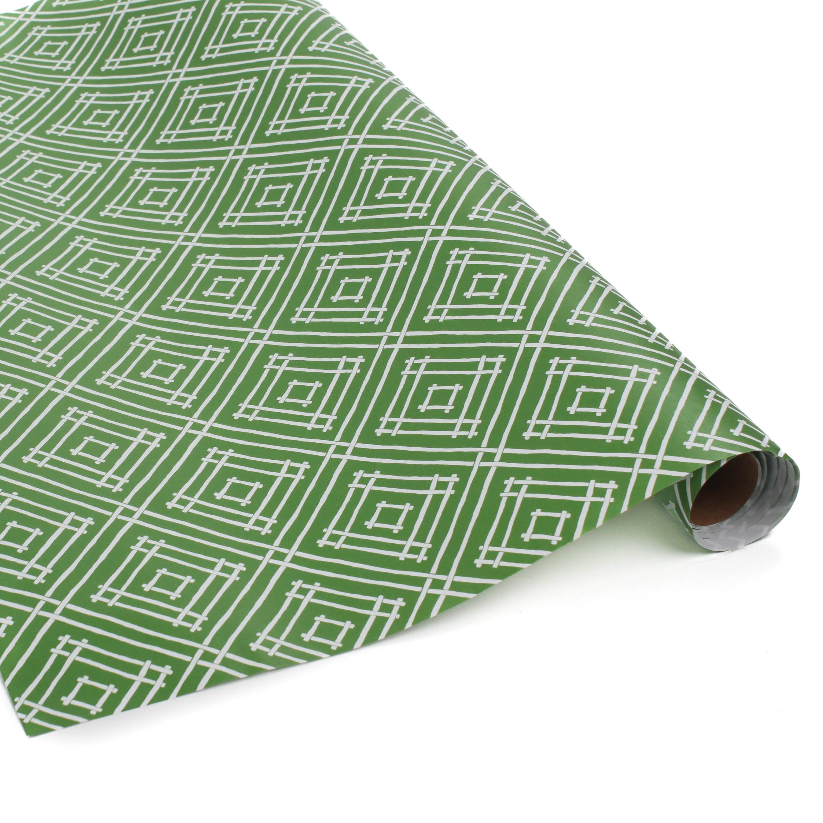 Rolls of wrapping paper with a geometric lattice pattern in green