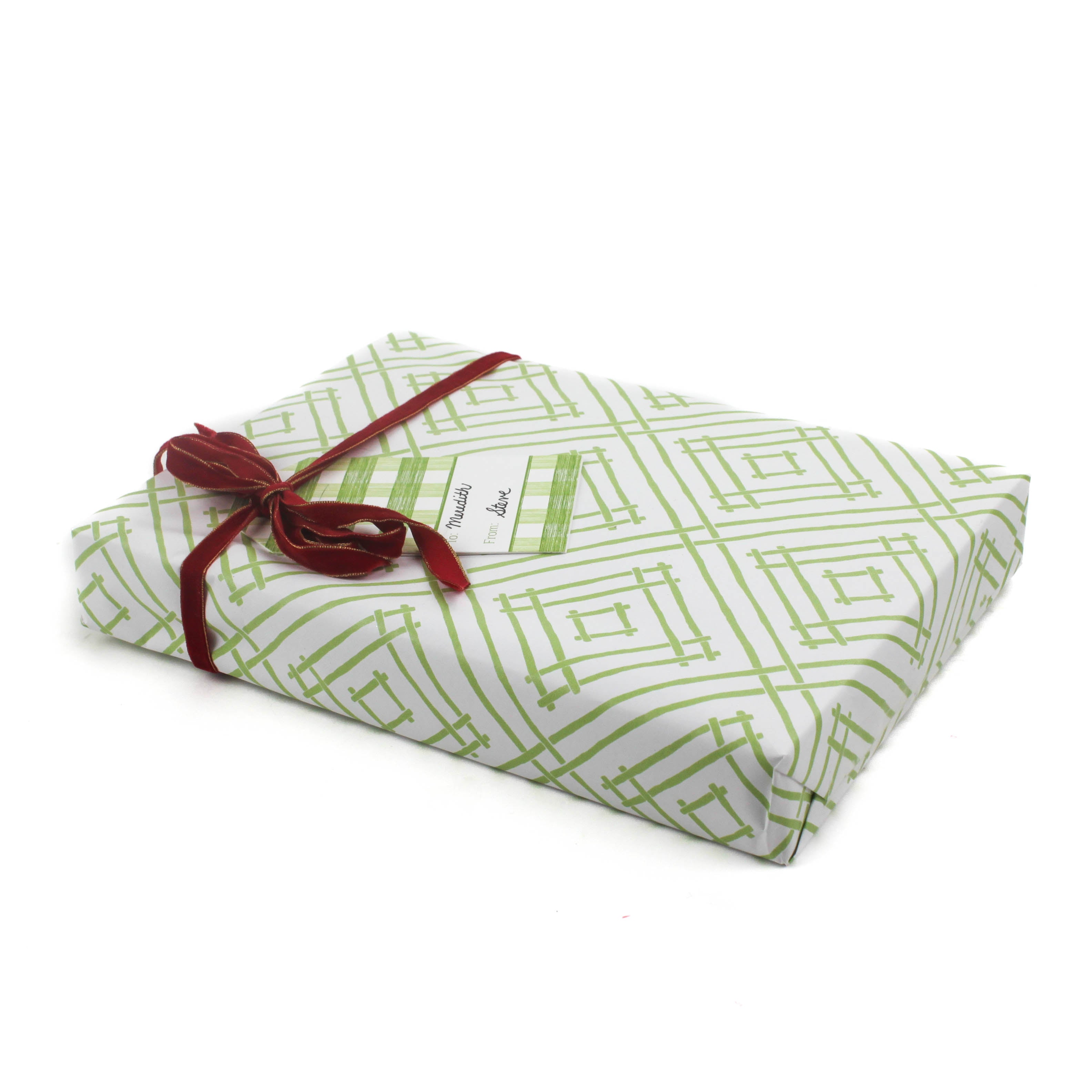 a roll of wrapping paper with a geometric lattice pattern in green
