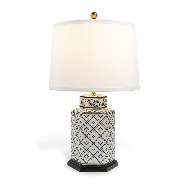 A small blue and white table lamp with a white lampshade