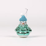 Glass snowman ornament with a blue hat and green jacket on a white background