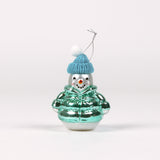 Glass snowman ornament with a blue hat and green jacket on a white background