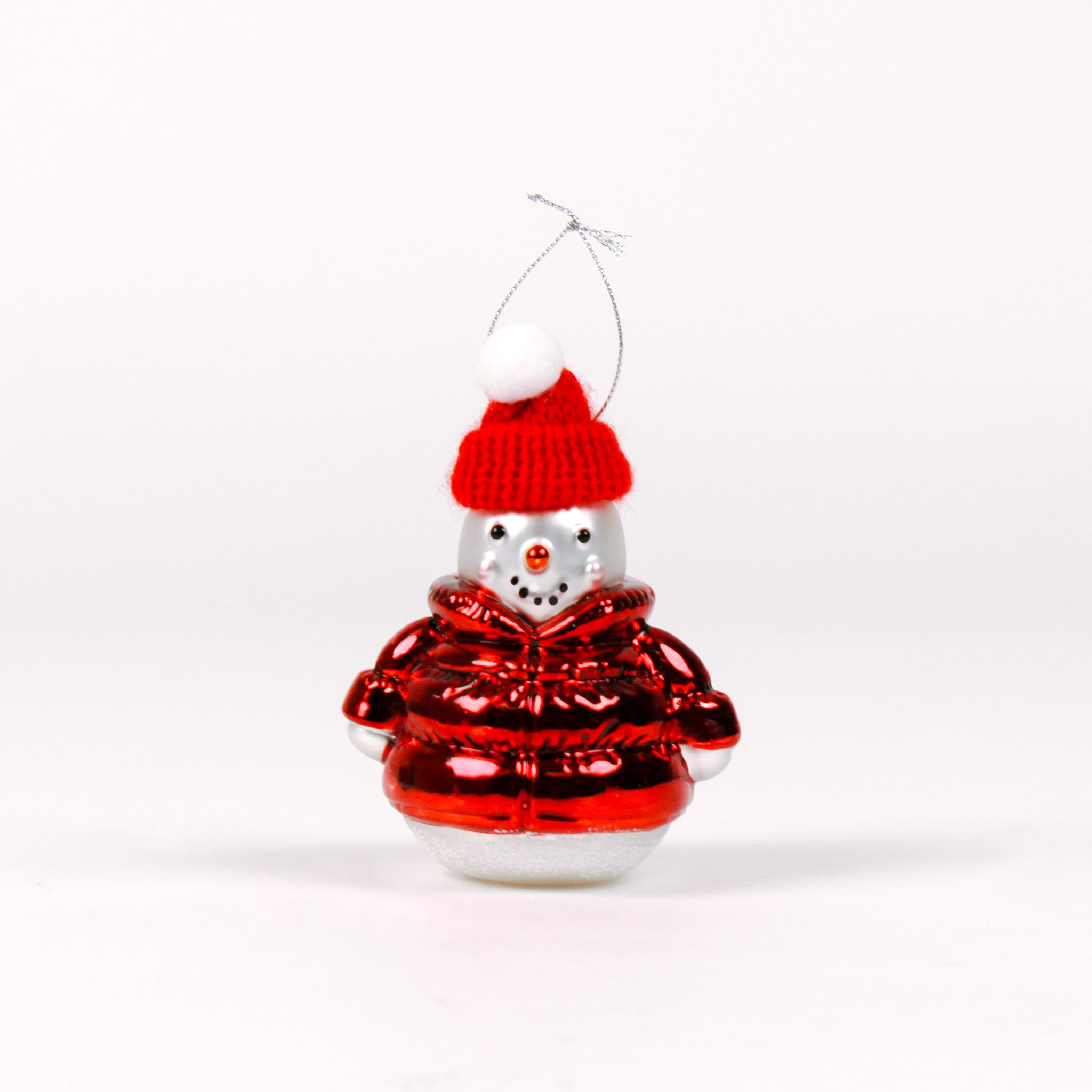 Decorative glass snowman ornament with a red hat and sweater on a white background