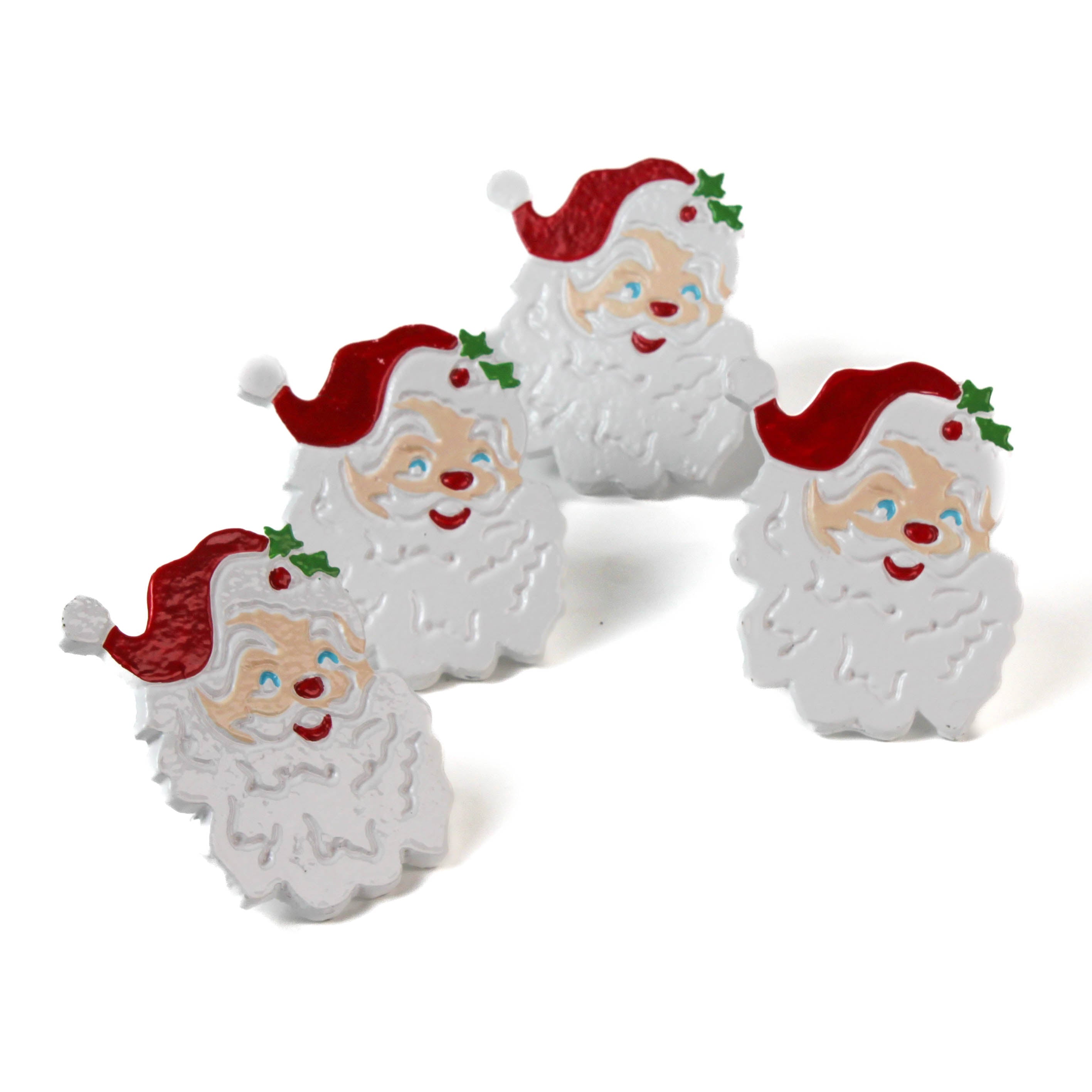 Four Santa Claus christmas napkin rings with red hats on a white background