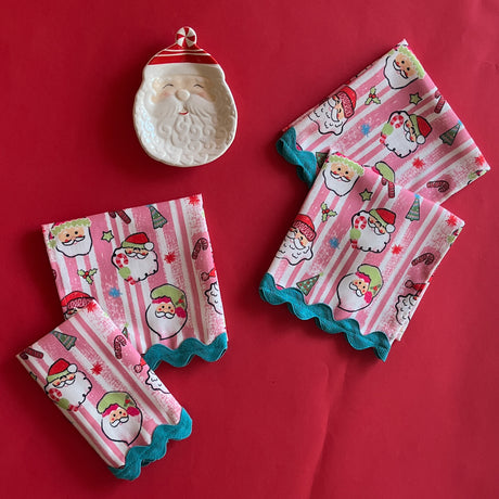 Jolly Santas Christmas Cloth Dinner Napkins with blue ric rac trim on a red backgroun