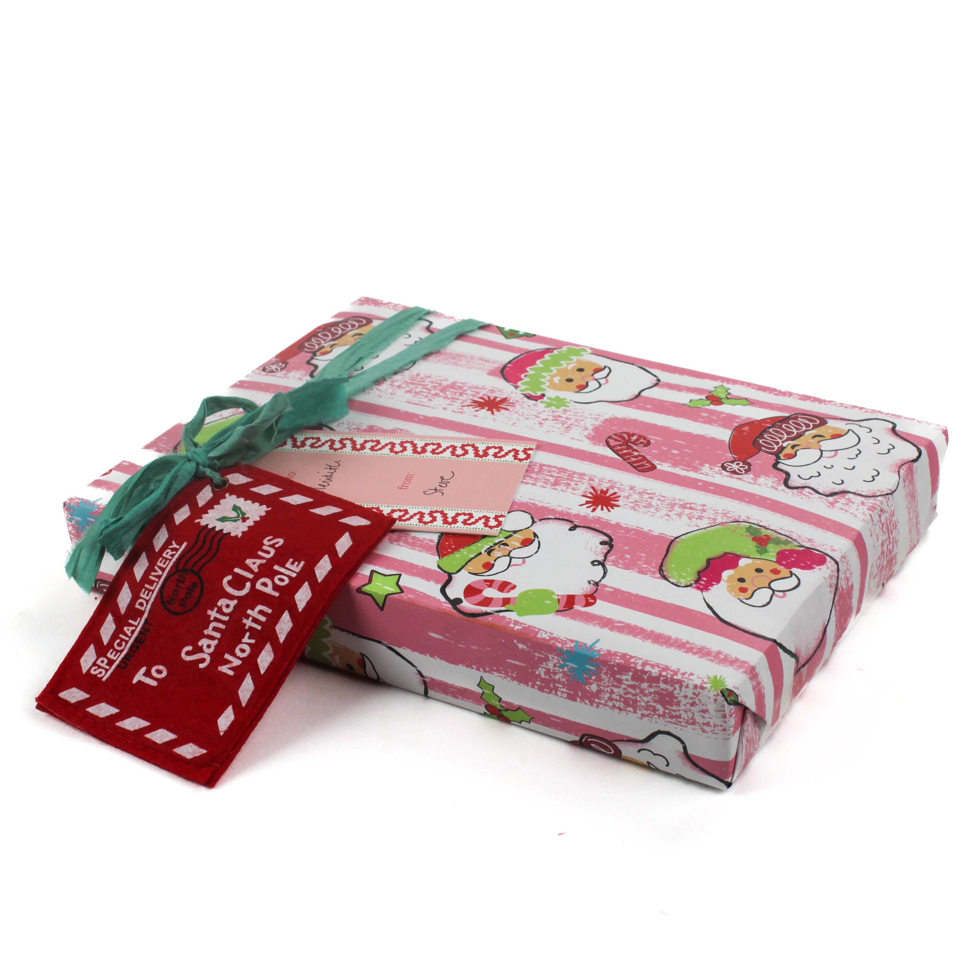 Colorful Christmas wrapping paper featuring santa, candy cane and christmas tree motifs. 