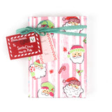 Colorful Christmas wrapping paper featuring santa, candy cane and christmas tree motifs. 