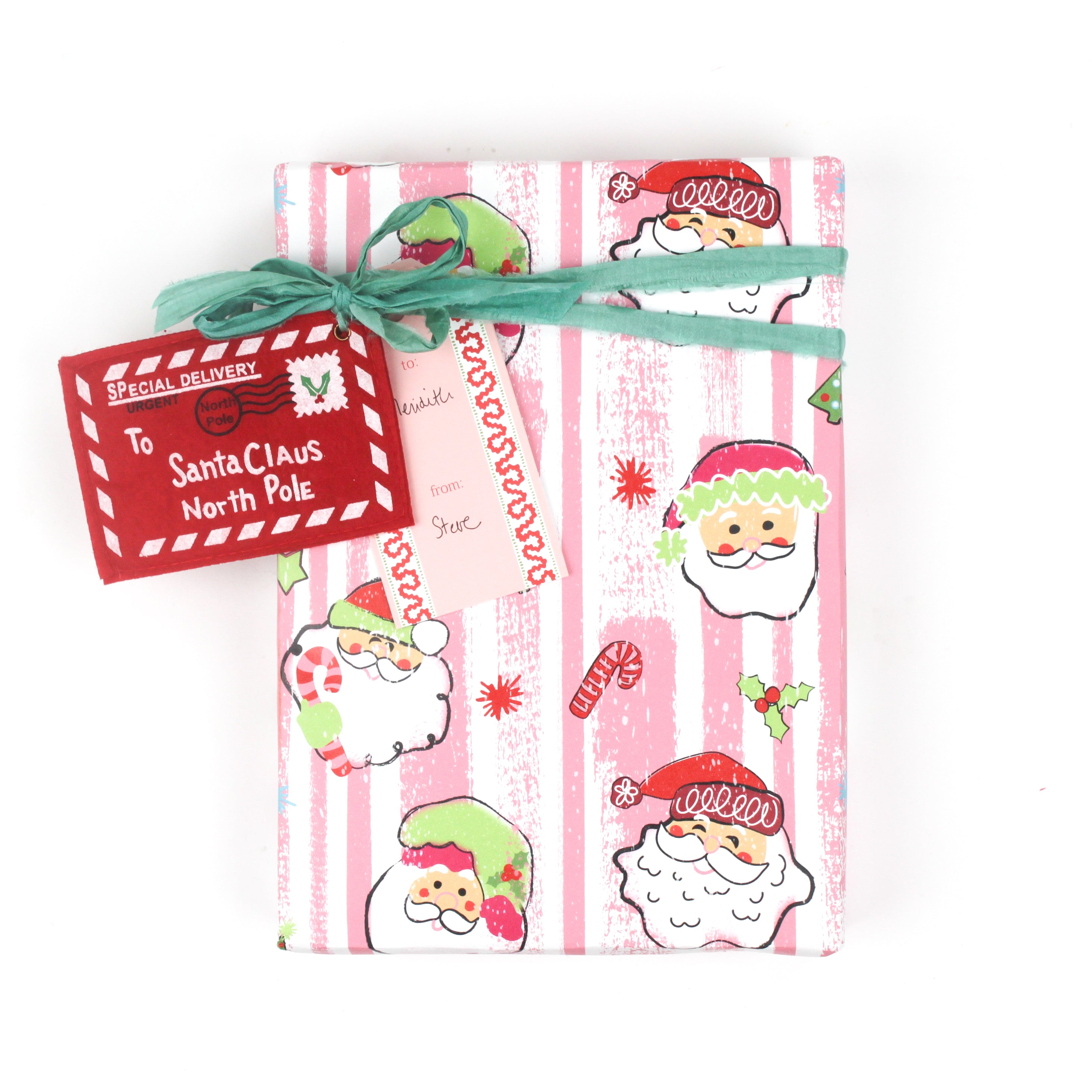 Colorful Christmas wrapping paper featuring santa, candy cane and christmas tree motifs. 