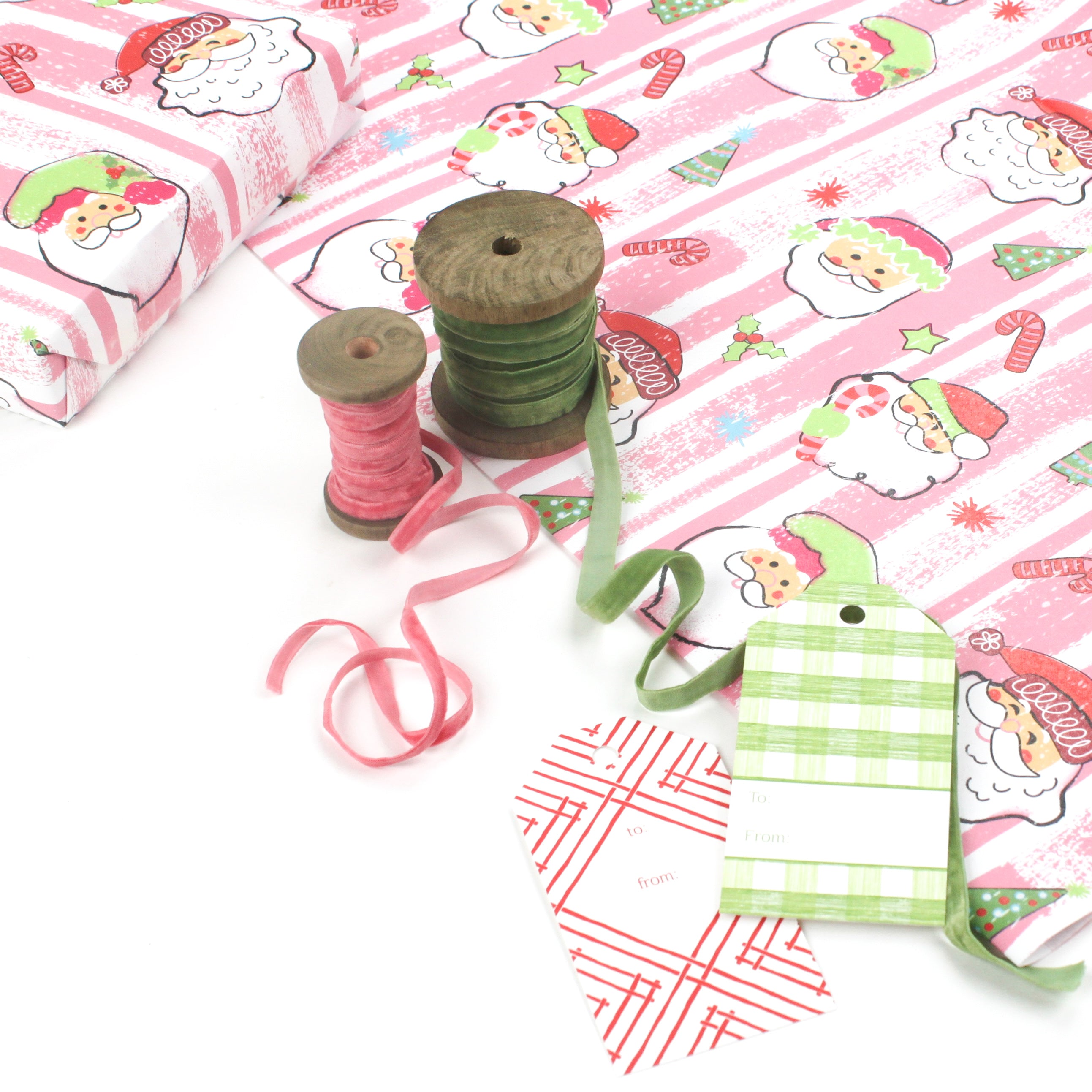 Colorful Christmas wrapping paper featuring santa, candy cane and christmas tree motifs. 