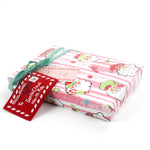 Colorful Christmas wrapping paper featuring santa, candy cane and christmas tree motifs. 