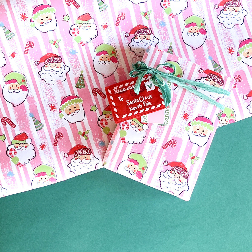 Colorful Christmas wrapping paper featuring santa, candy cane and christmas tree motifs. 